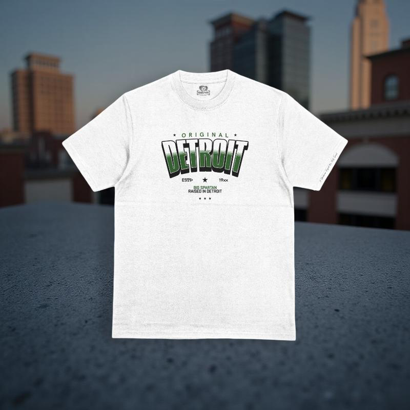 White t-shirt with 'Original Detroit' text on a blurred cityscape background